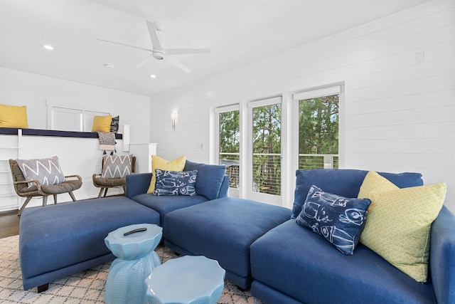 living room with wooden walls and ceiling fan