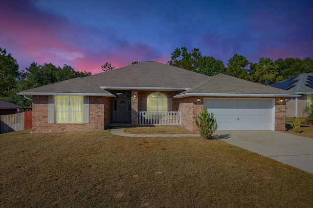 ranch-style house with a yard and a garage