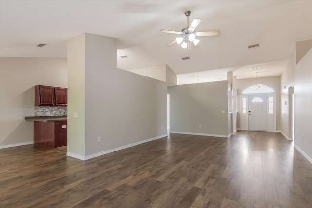 unfurnished living room featuring lofted ceiling, ceiling fan, and dark hardwood / wood-style flooring