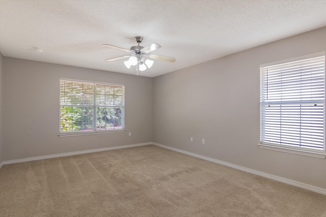 carpeted empty room featuring a textured ceiling and ceiling fan