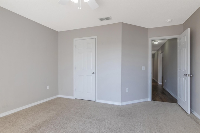 unfurnished bedroom with ceiling fan and carpet