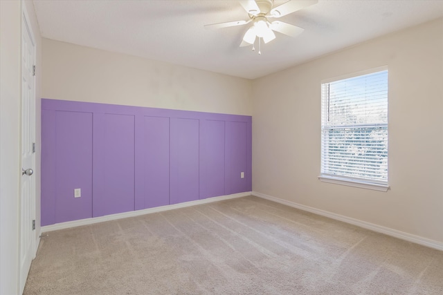 unfurnished room with light carpet and ceiling fan