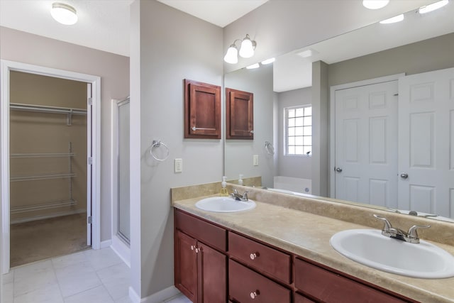 bathroom featuring vanity, tile patterned flooring, and a shower with door