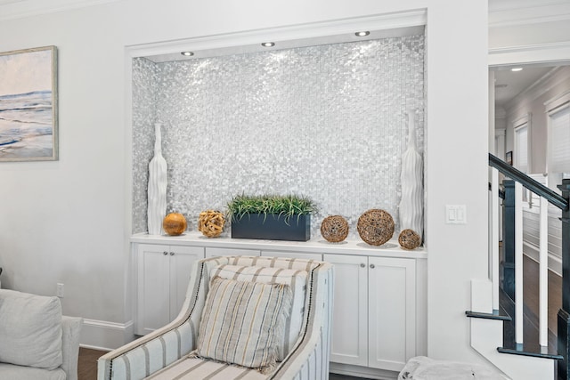 sitting room with crown molding and hardwood / wood-style flooring