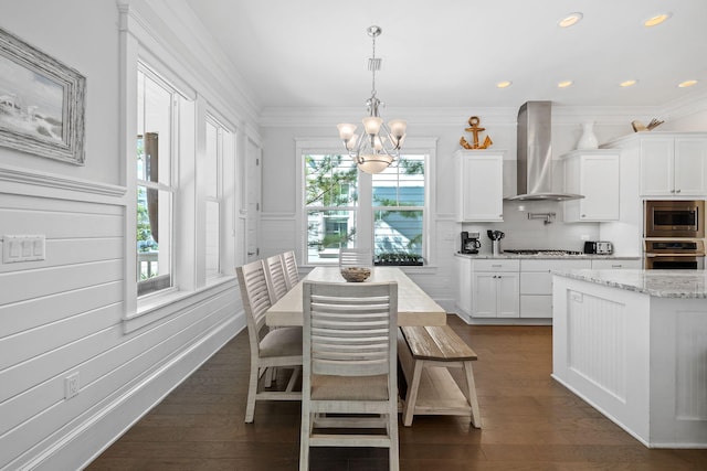 dining room with ornamental molding, dark hardwood / wood-style floors, an inviting chandelier, and plenty of natural light