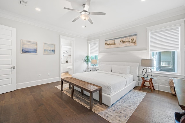 bedroom featuring connected bathroom, dark wood-type flooring, crown molding, and ceiling fan