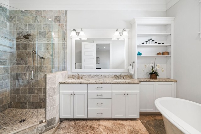 bathroom with vanity, crown molding, and shower with separate bathtub