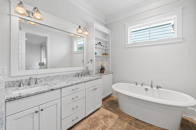 bathroom featuring vanity, crown molding, and a tub