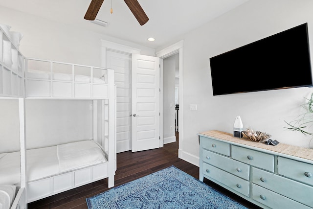 bedroom with dark hardwood / wood-style flooring, a closet, and ceiling fan