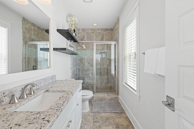 bathroom featuring toilet, an enclosed shower, and vanity