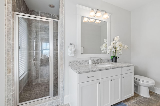 bathroom with toilet, an enclosed shower, vanity, and tile patterned floors