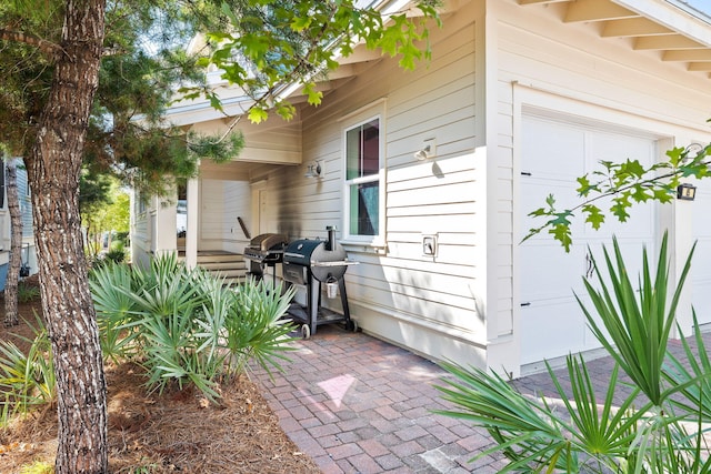 view of patio with a garage and a grill