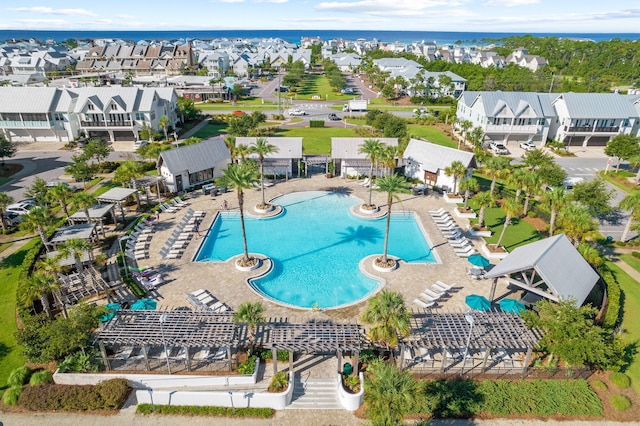 view of swimming pool featuring a patio and a water view