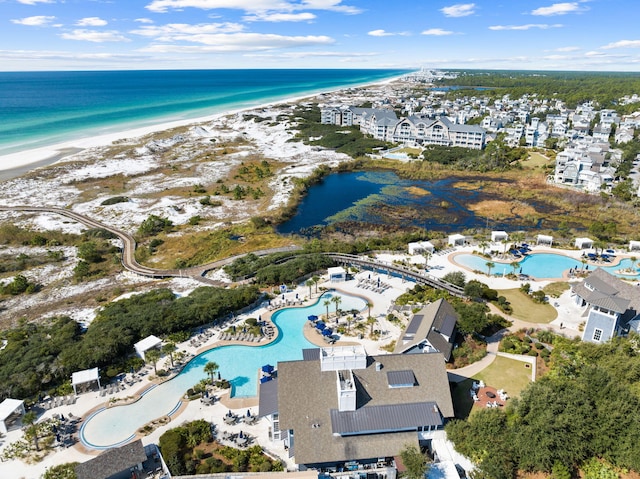 aerial view with a water view and a beach view