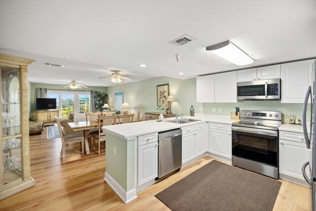 778 Scenic Gulf Dr Unit 423, Miramar Beach, FL 32550 - kitchen featuring appliances with stainless steel finishes, a peninsula, white cabinetry, recessed lighting, and light wood finished floors