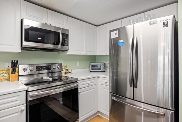 778 Scenic Gulf Dr Unit 423, Miramar Beach, FL 32550 - kitchen featuring stainless steel appliances, white cabinets, and light countertops
