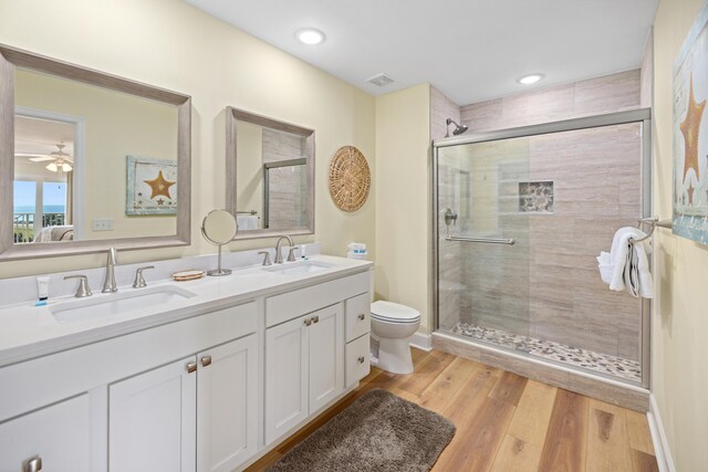 778 Scenic Gulf Dr Unit 423, Miramar Beach, FL 32550 - full bath with a stall shower, toilet, double vanity, wood finished floors, and recessed lighting