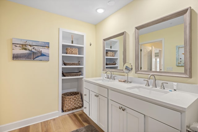 778 Scenic Gulf Dr Unit 423, Miramar Beach, FL 32550 - bathroom with wood finished floors, double vanity, built in shelves, and baseboards