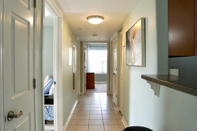 corridor with light tile patterned floors