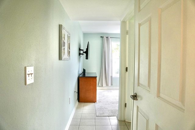 corridor featuring light tile patterned flooring