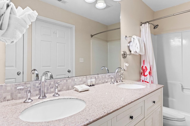 full bathroom with vanity, backsplash, shower / bath combo, and toilet