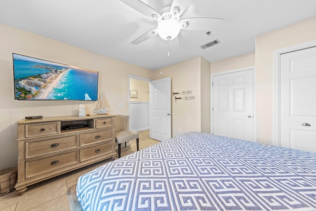 tiled bedroom featuring ceiling fan