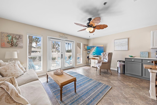 living room featuring french doors, a healthy amount of sunlight, and ceiling fan