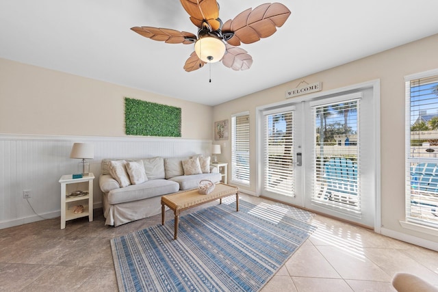 living room featuring french doors, light tile patterned floors, a wealth of natural light, and ceiling fan