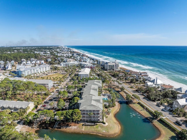 drone / aerial view with a water view and a beach view