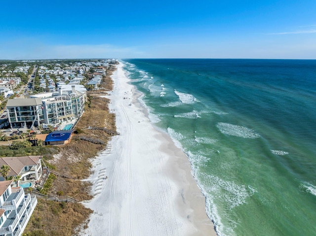 drone / aerial view featuring a water view and a beach view