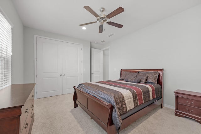 carpeted bedroom featuring a closet and ceiling fan