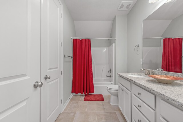 full bathroom with toilet, vanity, tile patterned floors, and shower / tub combo