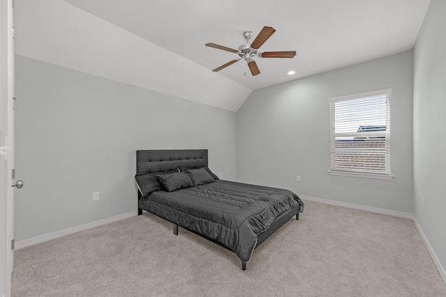 bedroom featuring ceiling fan, vaulted ceiling, and light colored carpet