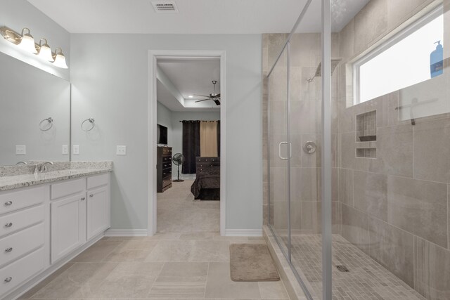 bathroom with vanity, tile patterned floors, ceiling fan, and walk in shower