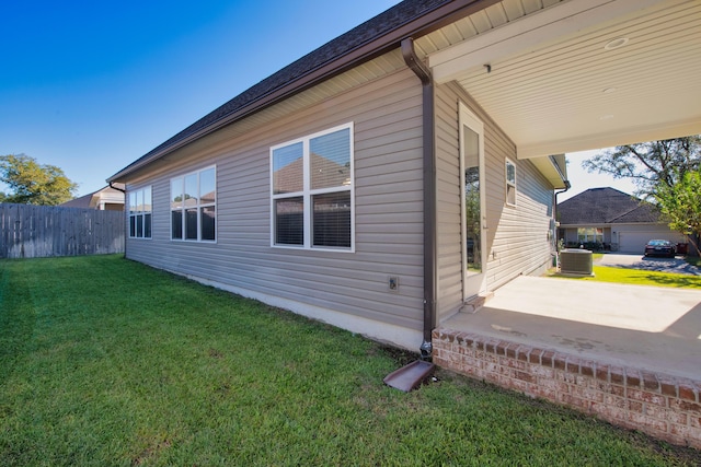 view of home's exterior featuring a patio area, central AC unit, and a lawn