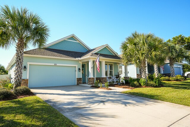 view of front of property with a front yard and a garage