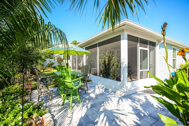 view of patio / terrace featuring a sunroom