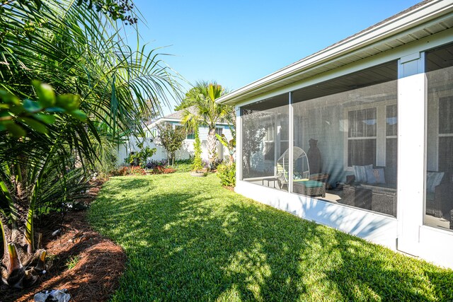 view of yard featuring a sunroom