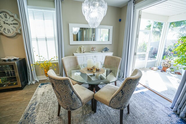 dining room featuring hardwood / wood-style floors, a chandelier, and plenty of natural light