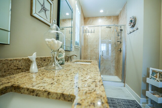 bathroom with sink and a shower with shower door