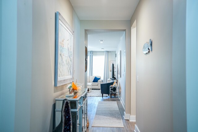 corridor with hardwood / wood-style floors