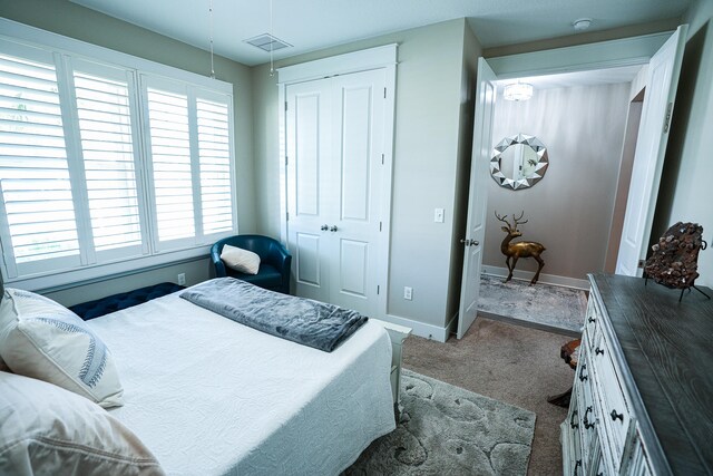 carpeted bedroom with a closet