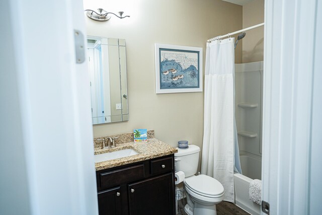 full bathroom with vanity, toilet, shower / tub combo with curtain, and hardwood / wood-style floors