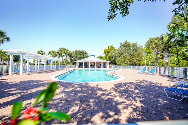 view of swimming pool featuring a patio, a gazebo, and a pergola