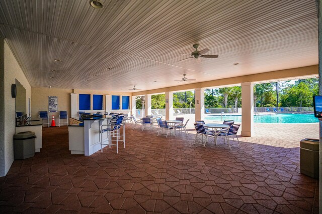 view of patio / terrace with a community pool and ceiling fan