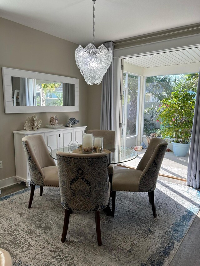 dining area featuring a notable chandelier and hardwood / wood-style floors