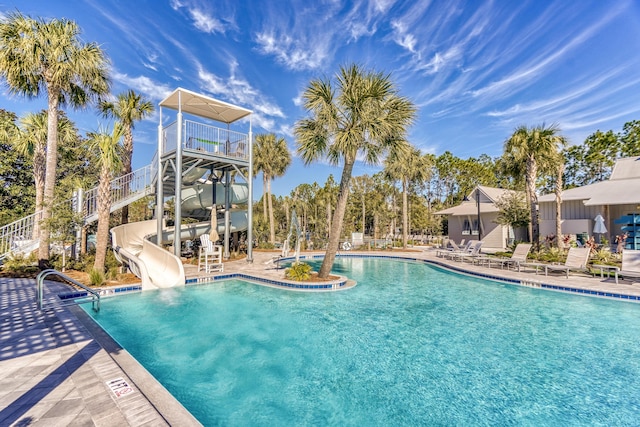 view of pool featuring a water slide and a patio area