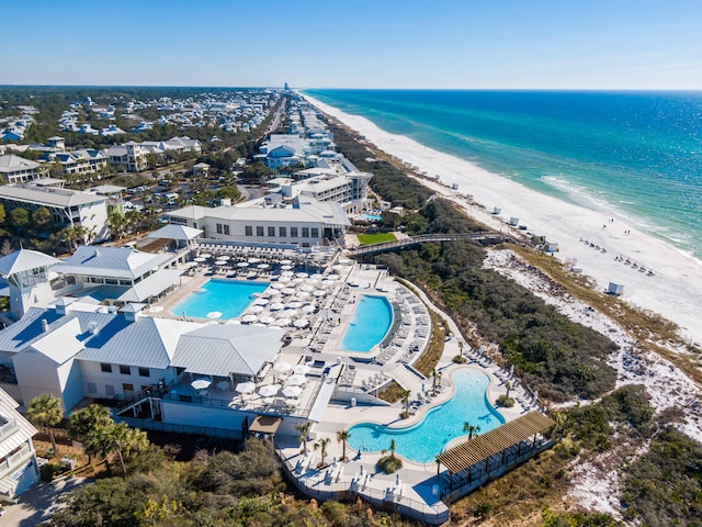 drone / aerial view featuring a water view and a view of the beach