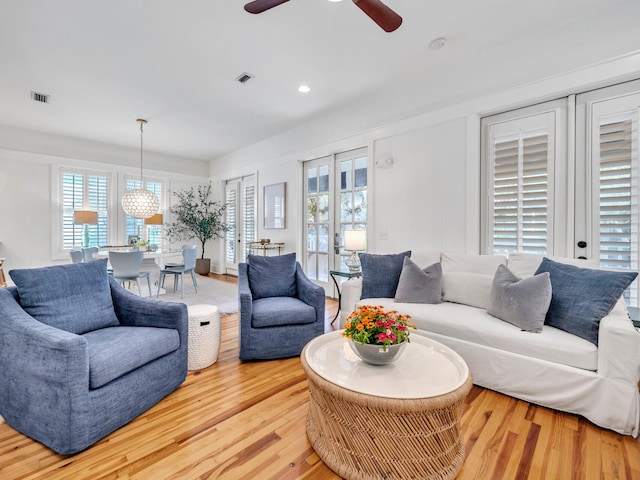 living room featuring ceiling fan and light hardwood / wood-style flooring