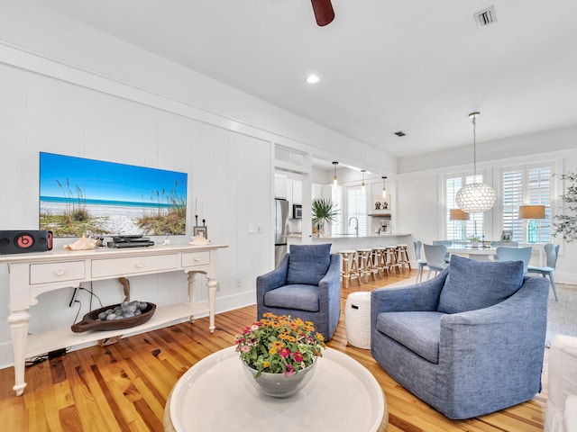 living room featuring light hardwood / wood-style flooring and sink